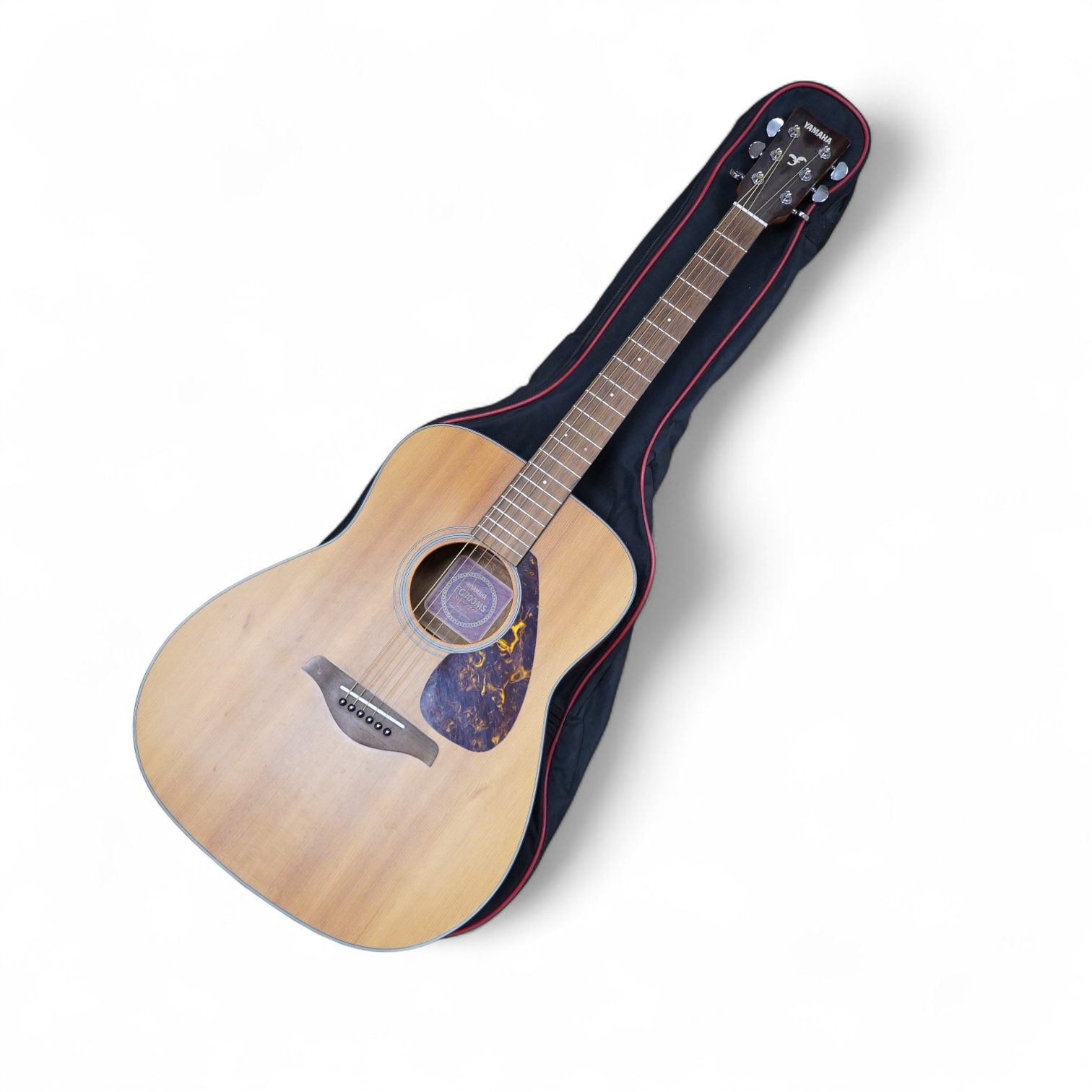 A Yamaha FG700MS acoustic guitar with a soft carry case